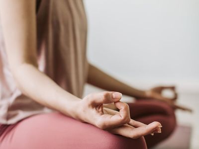 Close-up of hands in a meditative mudra position during yoga practice.