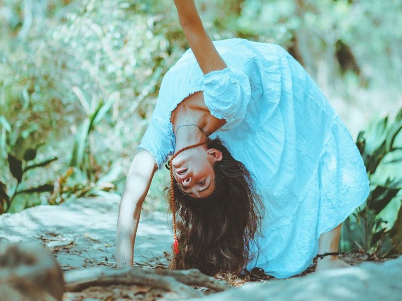 Person holding a challenging yoga balance pose with serene expression.